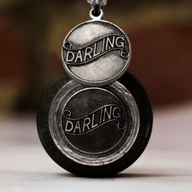 Vintage sterling silver darling pendant pictured with antique hand-engraved hub
